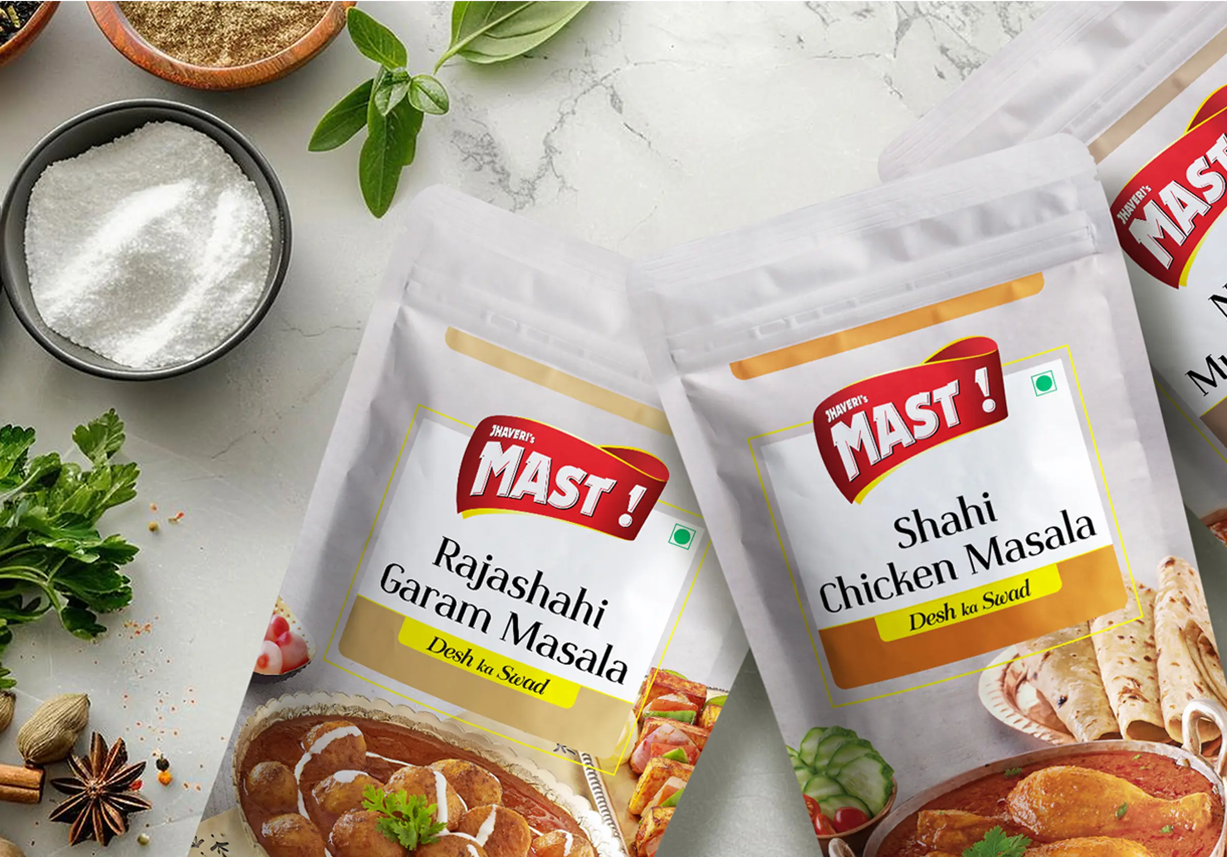 Mast Masala spice packaging flat lay with herbs and whole spices